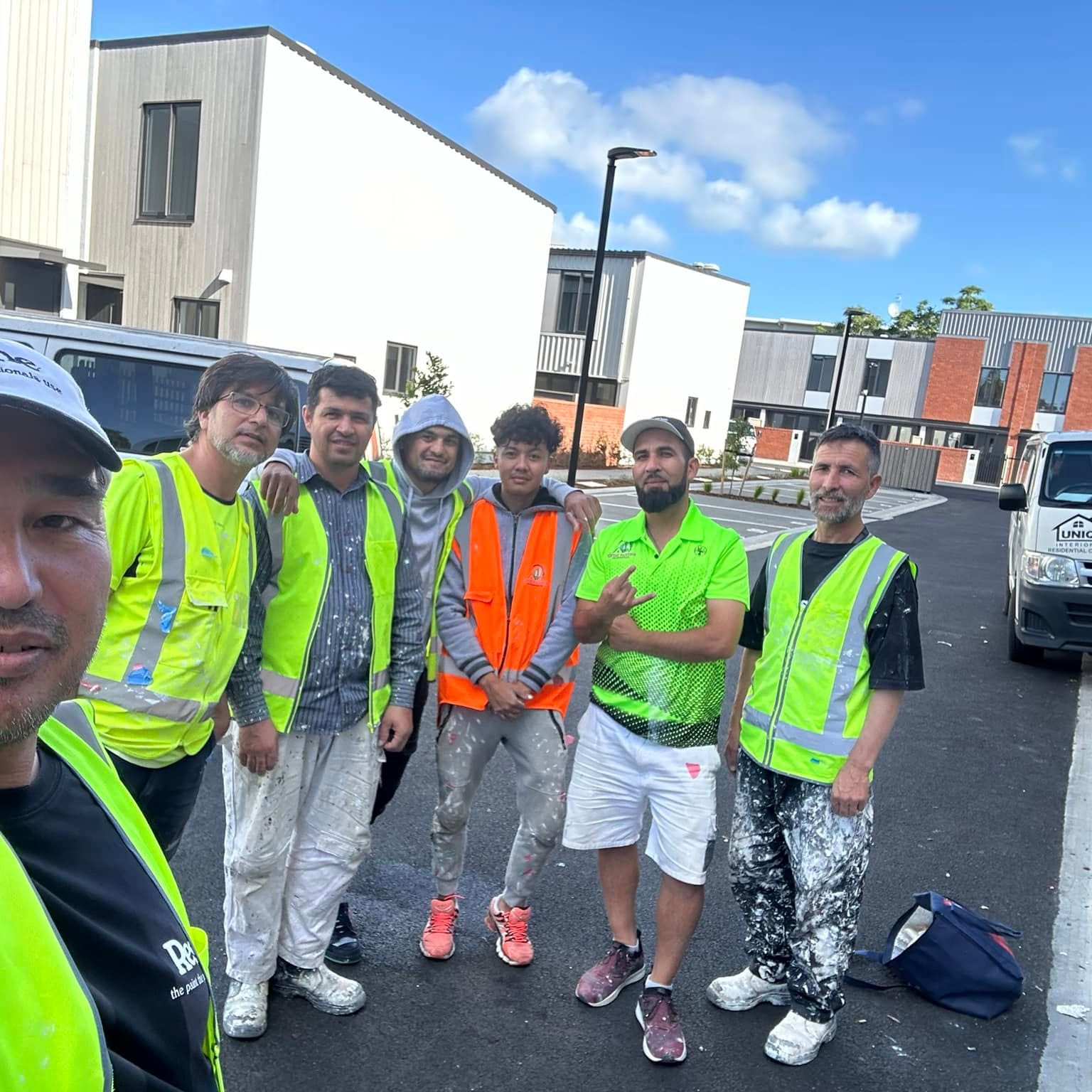 The Rush & Brush crew in branded hi-vis on a finished townhouse development in West Auckland