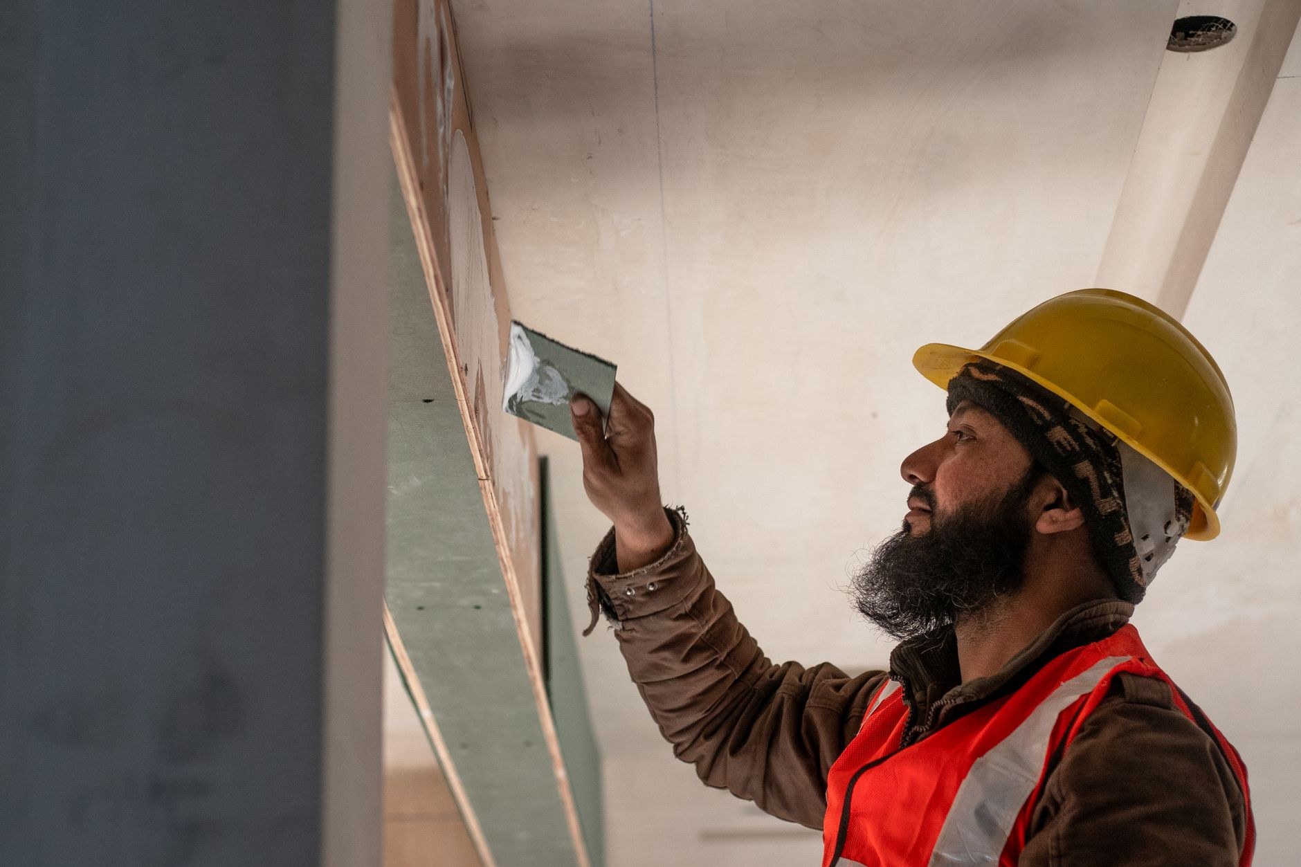 Plasterer skimming a wall to a smooth finish